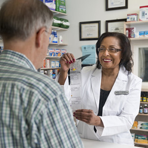 Pharmacist displays PASS adherence packaging Pharmacist displays PASS adherence packaging