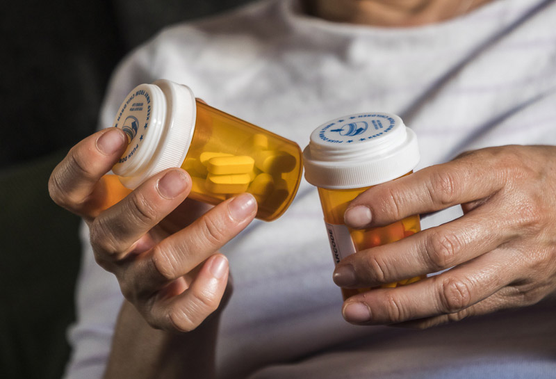 Woman examining medication vials